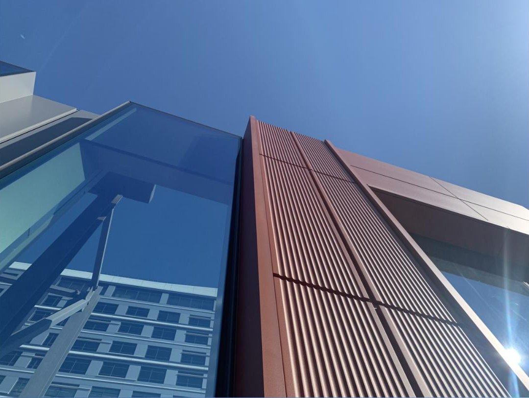 A glass building facade, the kind of enclosure work Building Enclosure Science consults on