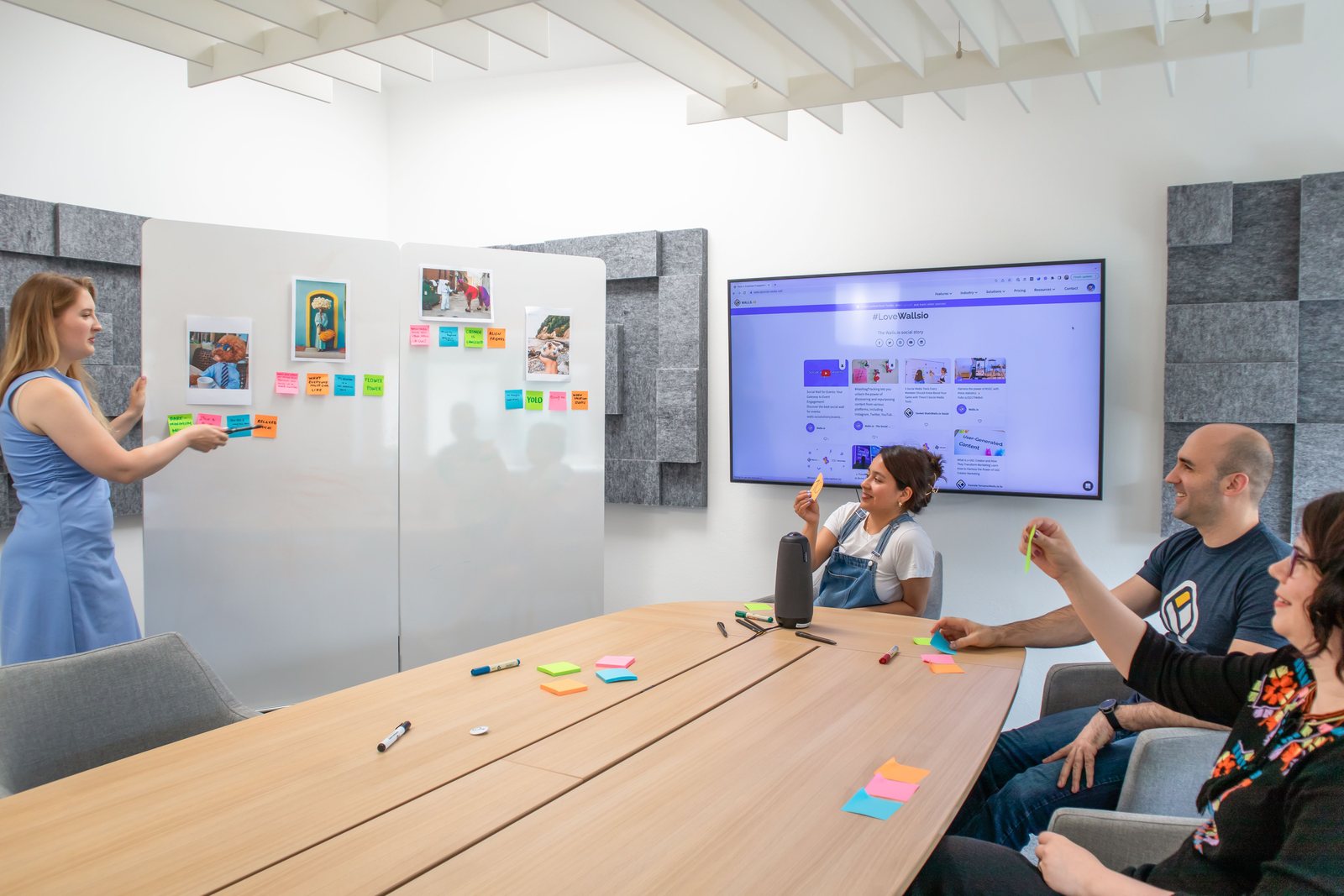 A facilitated team meeting working through ideas on whiteboards